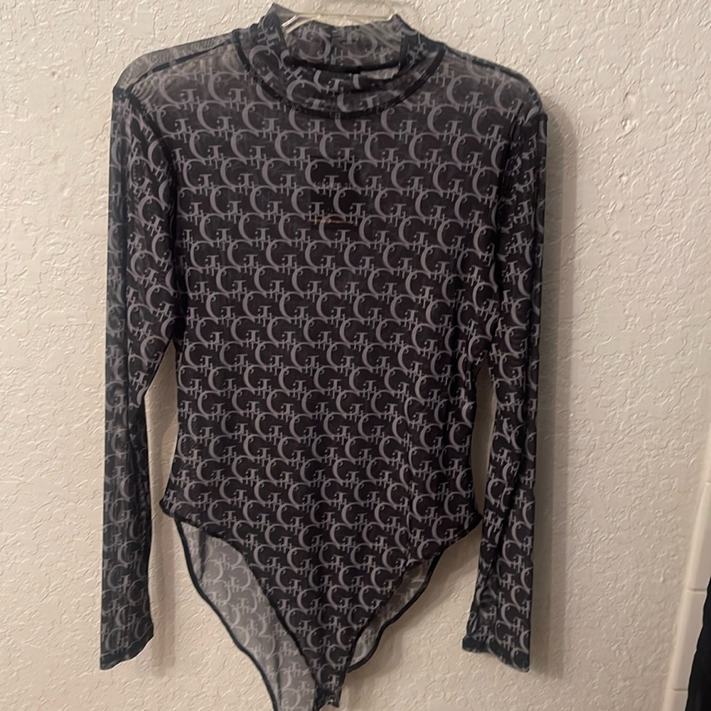 A cute bodysuit repeating “Girls” nice material it’s also see through.